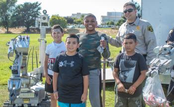 Photo of 4 boys with a police officer.